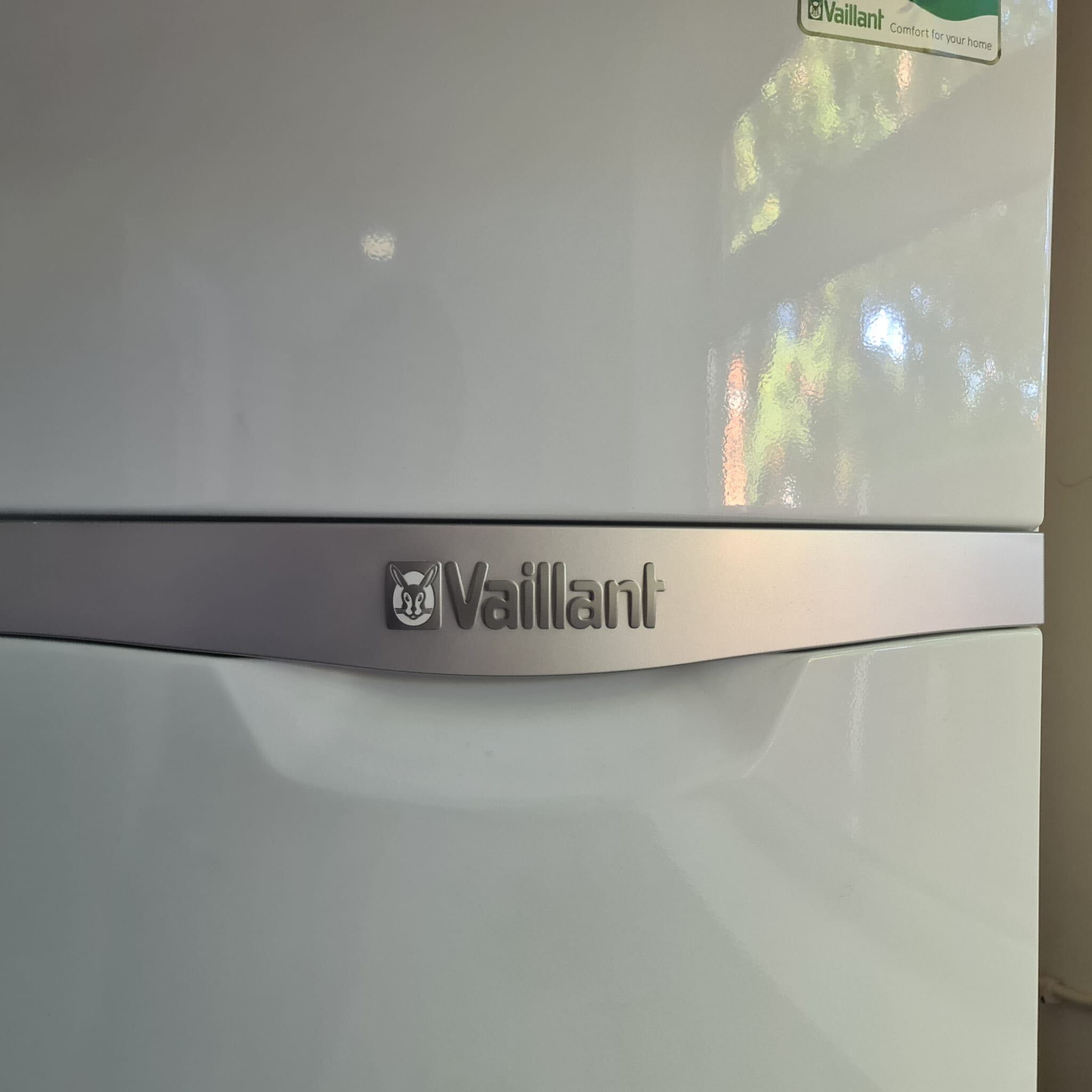 Close-up of the Vaillant ecoTEC boiler badge on a freshly installed white boiler casing. Emergency plumbing and heating repair completed in Ealing W5, The Bearded Property Co, 020 8050 9389