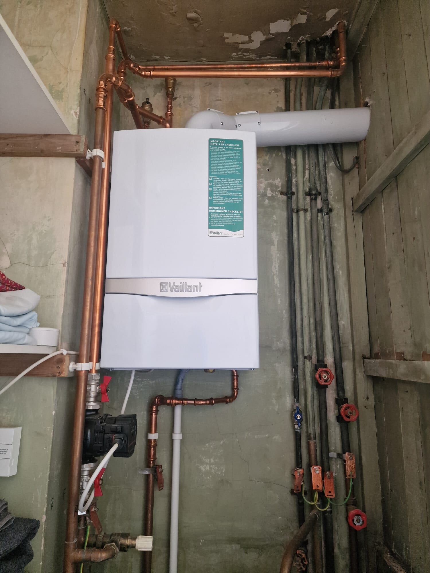 New Vaillant ecoTEC boiler with fresh copper pipework and zone valves in an older property cupboard. No heating no hot water emergency callout service in Ealing, The Bearded Property Co, 020 8050 9389