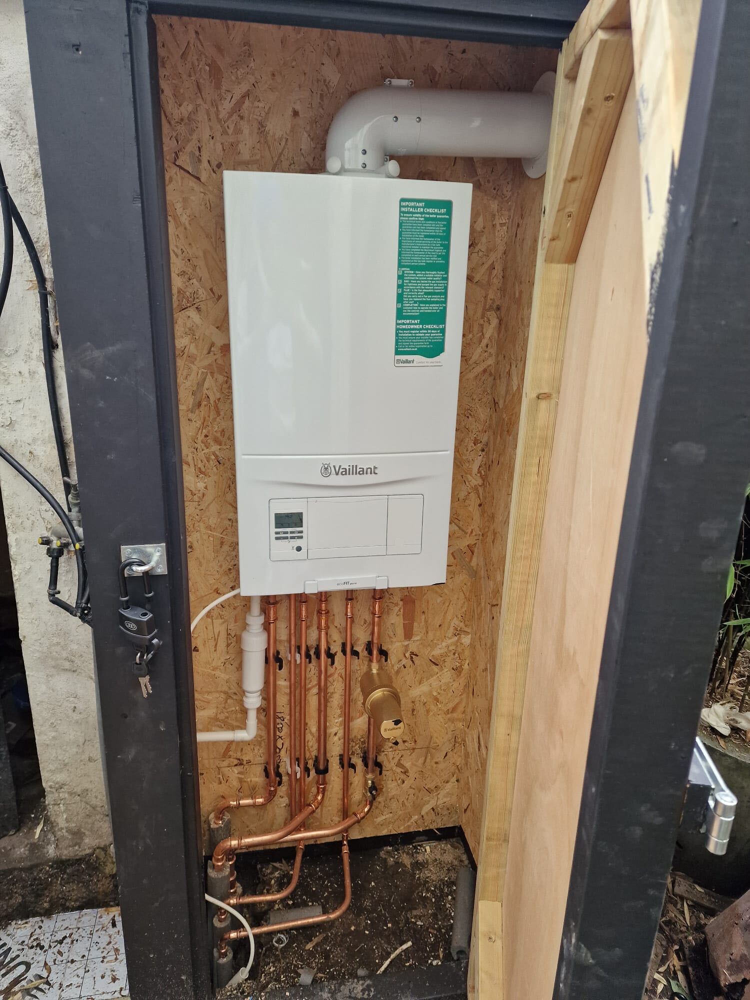Vaillant ecoFIT pure boiler in a lockable external timber boiler enclosure with insulated pipework and flue, Ealing and West London, The Bearded Property Co, 020 8050 9389